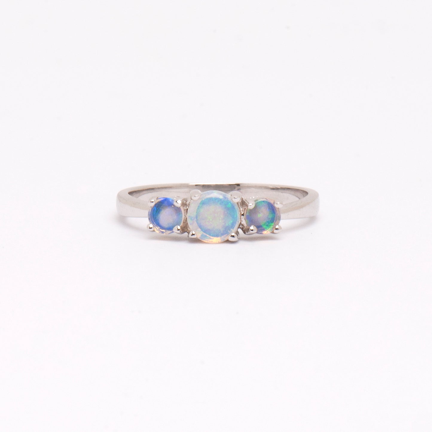 Sterling Silver Crystal Opals 3 Stone Ring. The ring features round-cut opals in shades of green and blue, set in a claw setting. The opals exhibit captivating play of colors and natural beauty | Opalist
