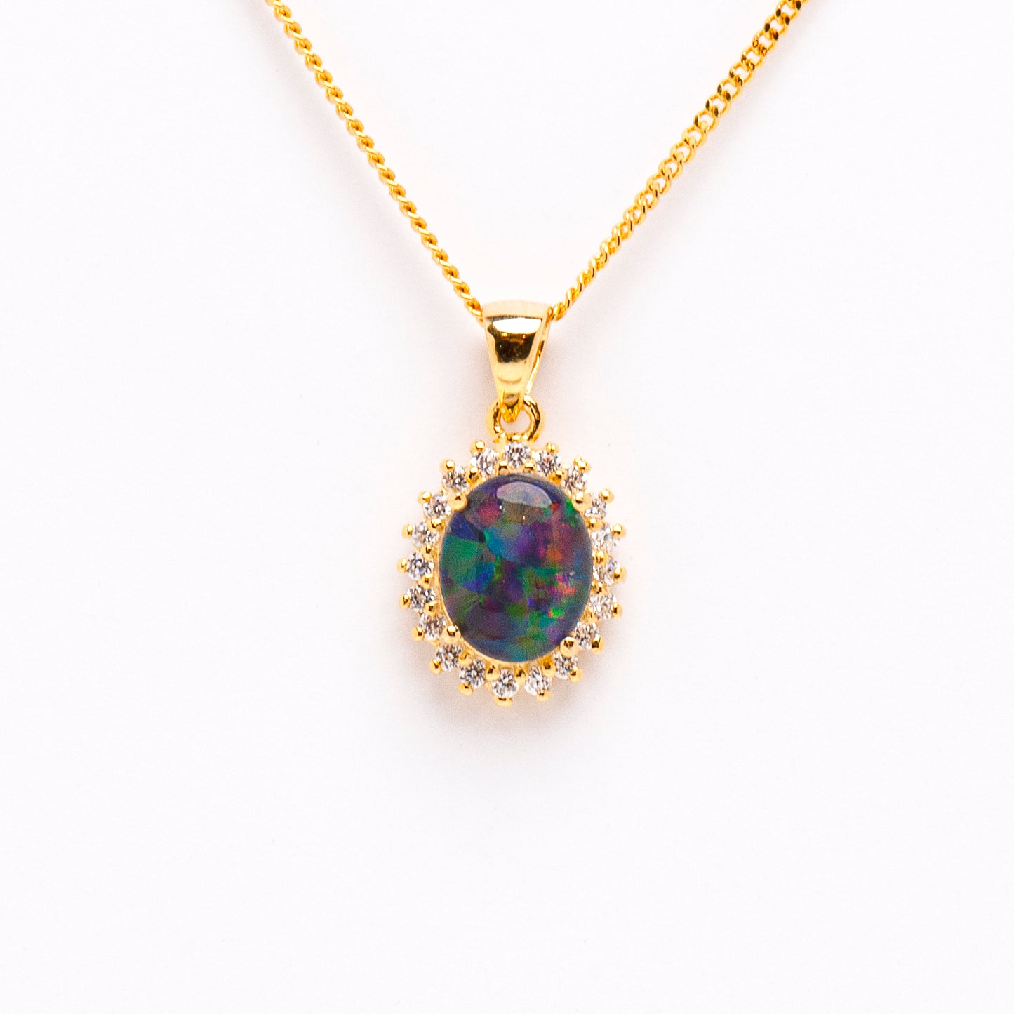Gold-Plated Sterling Silver Triplet Opal Pendant. The pendant features an oval-cut triplet opal in vibrant shades of green, yellow, red, and blue. The opal is claw-set with a halo design adorned with cubic zirconia | Opalist