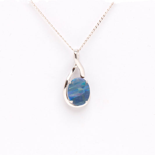A Sterling Silver Doublet Opal Pendant featuring an oval-cut opal with a unique stripe pattern. The opal displays an array of rainbow colours against a deep blue background, set in a sleek sterling silver claw setting | Opalist