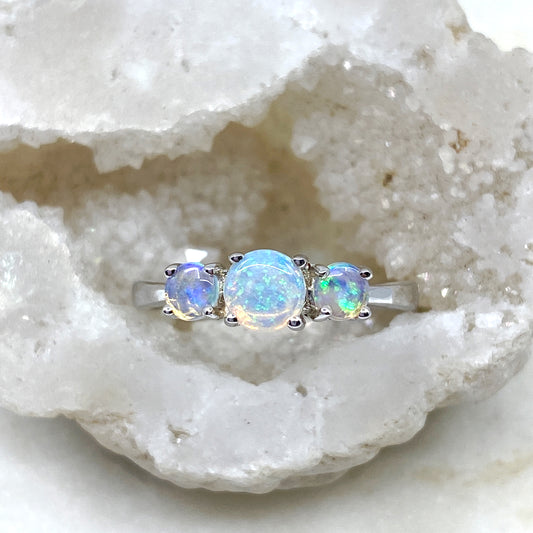 Sterling Silver Crystal Opals 3 Stone Ring. The ring features round-cut opals in shades of green and blue, set in a claw setting. The opals exhibit captivating play of colors and natural beauty | Opalist